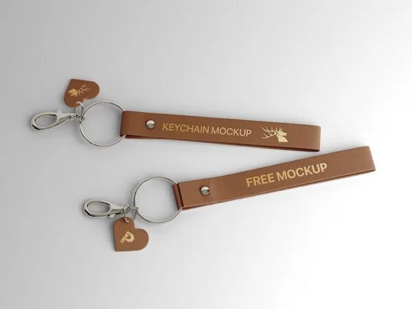 2 Leather Keyrings Laid on the Surface in Top View Mockup 1