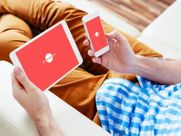 34 View Man Holding a Smart Phone and a Tablet Mockup 1