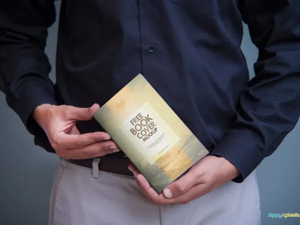 A Book Cover Mockup Held by a Man 1