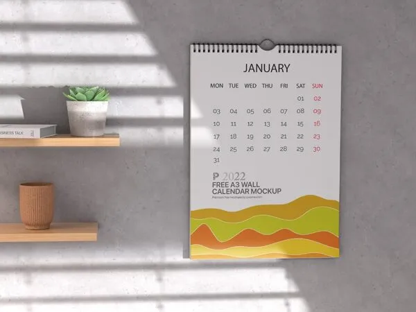 A3 Calendar Hung on the Wall Mockup Featuring Wooden Shelves and Plant Pots 1