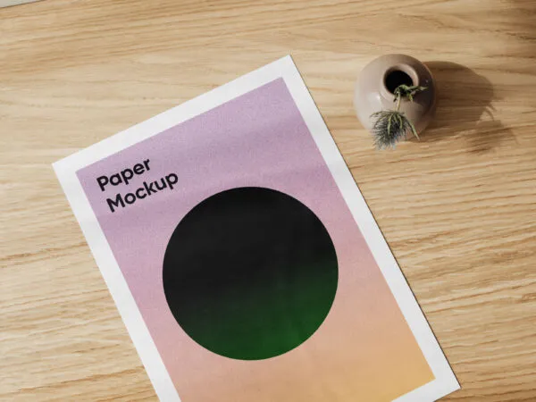 A4 Card on a Wooden Table Beside a Vase Mockup 1