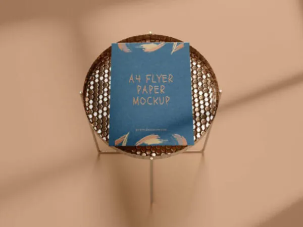 A4 Flyer Mockup in the Overhead View Featuring a Round Side Table 1