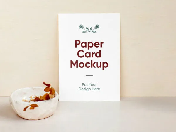 A4 Paper Against Wall Beside a Bowl Containing Dried Leaves Mockup 1