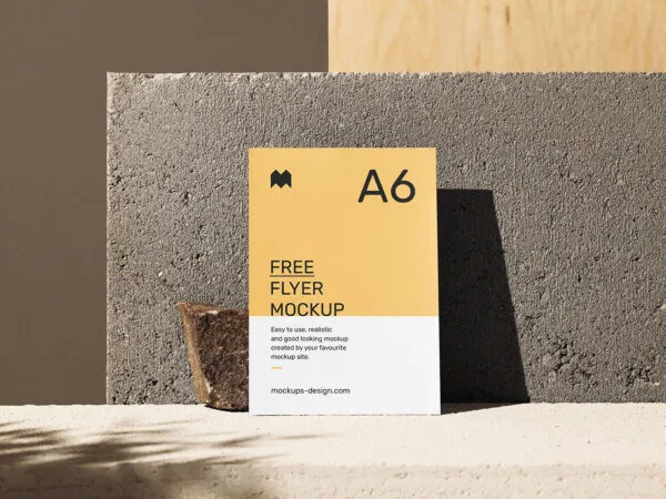 A6 Flyer Mockup in Front of a Concrete Block 1