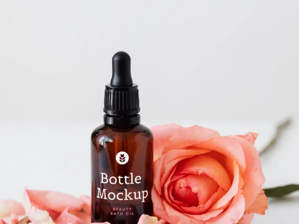 Beauty Bottle Next to a Pink Rose Mockup 1