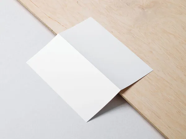 Bifold Dl Flyer Lying on a Wooden Board Mockup 1