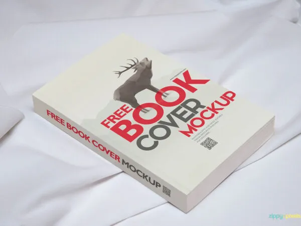 Book Mockup Laid on Cotton Sheet in Perspective 1