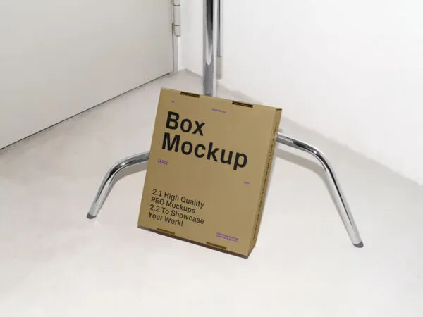 Cardboard Box Leaning Against Tripod Mockup 1