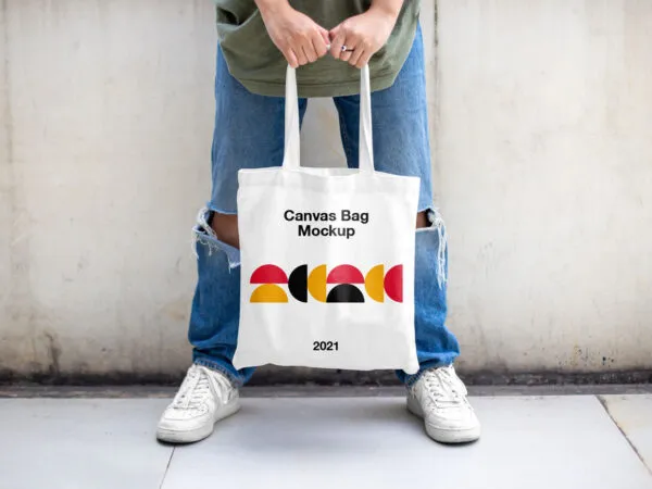Casual Outdoor Man Holding Canvas Bag Mockup from Front View 1
