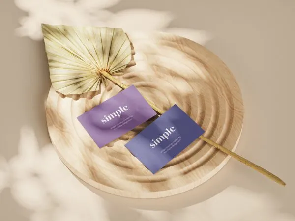 Close up View of Three Business Card Mockups on a Wooden Ornament 1