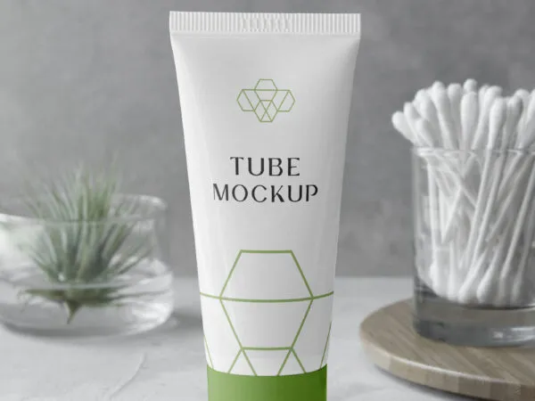Cosmetic Tube Mockup with a Plant on the Left Side and Ear Sticks on the Right Side 1