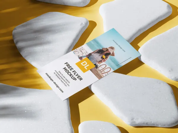 DL Flyer on White Stones with Overlaid Tree Shadow Mockup 1