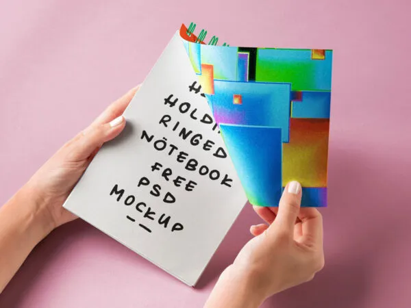 Facing View of Hand Holding Ringed Notebook Mockup 1