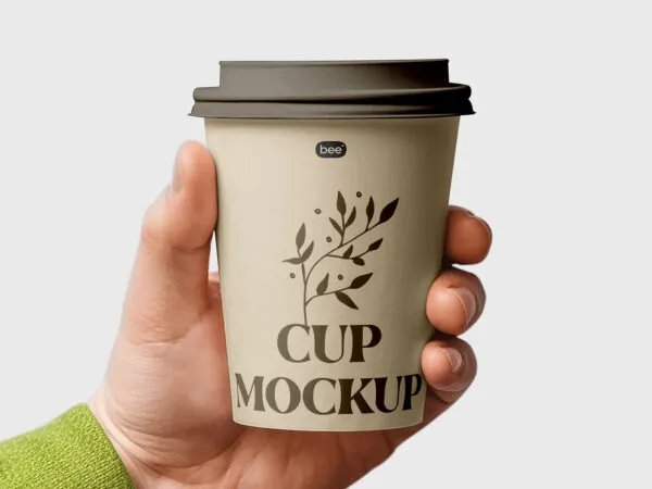 Facing View of Medium Paper Cup Mockup in Hand 1