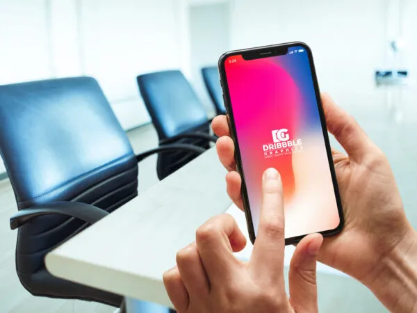 Female Hands Using iPhone X in Conference Room Mockup 1