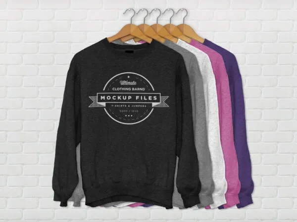 Five Crew Neck Jumpers on Cloth Hangers in a Row Mockup 1