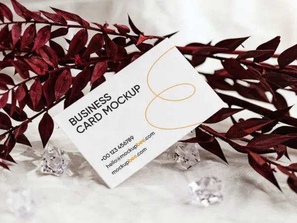 Front View of Business Card Mockup Standing at Angle with Leaf 1