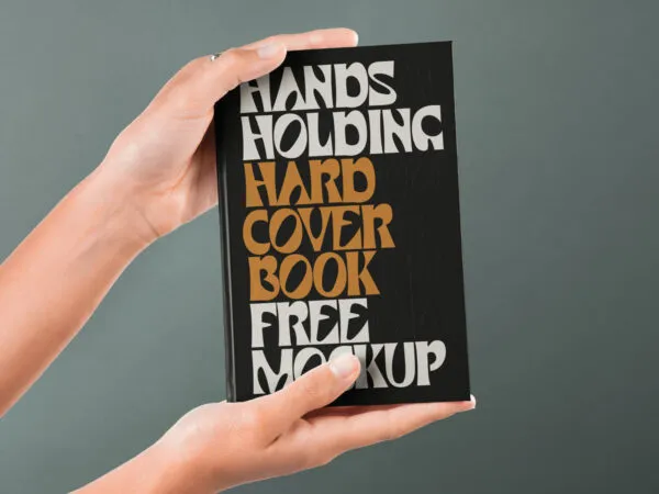 Front View of Hand Holding Hardcover Book Mockup 1