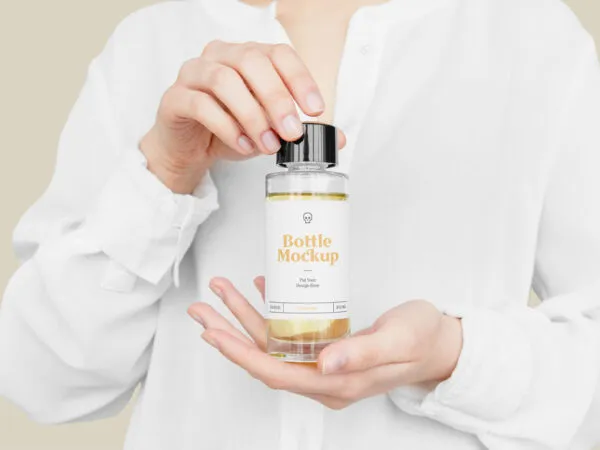 Front View of Hand Holding Plastic Bottle Mockup 1