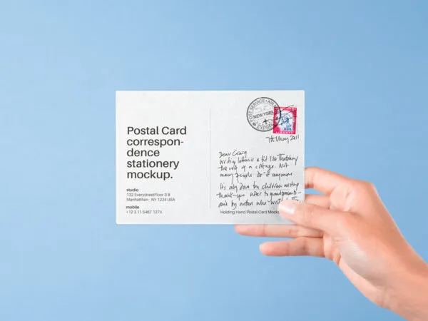 Front View of Hand Holding Postal Card Mockup 1