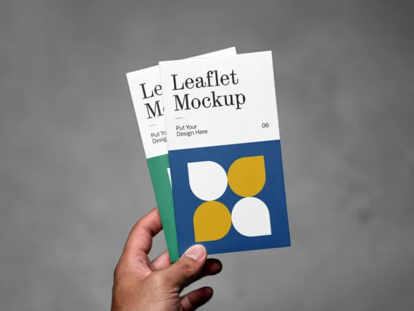 Front View of Hand Holding Vertical Leaflets Mockup 1