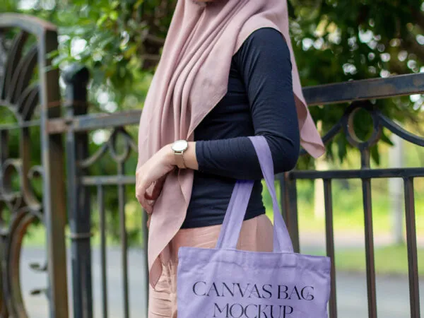 Front View of Woman Holding Canvas Bag Mockup 1