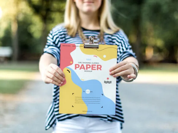 Front View of a Girl Showing Clipped Paper Mockup 1