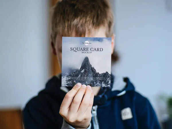 Front View of a Little Boy Showing a Square Card Mockup 1