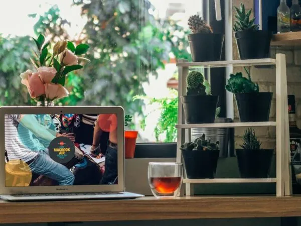 Front View of a MacBook Air in a Green Environment Mockup 1