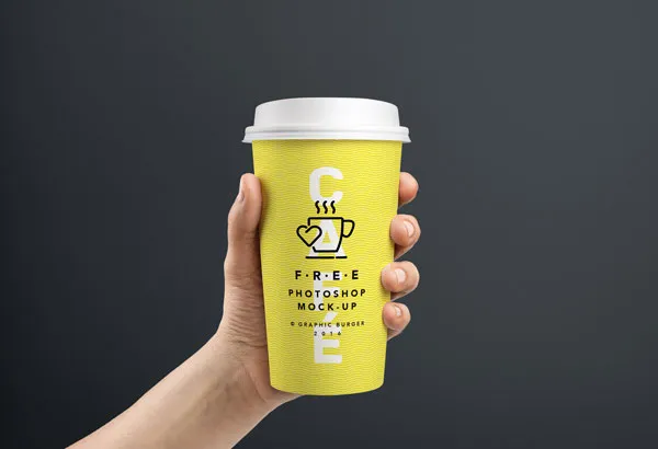 Hand Holding Coffee Cups in Two Sizes Mockup 1