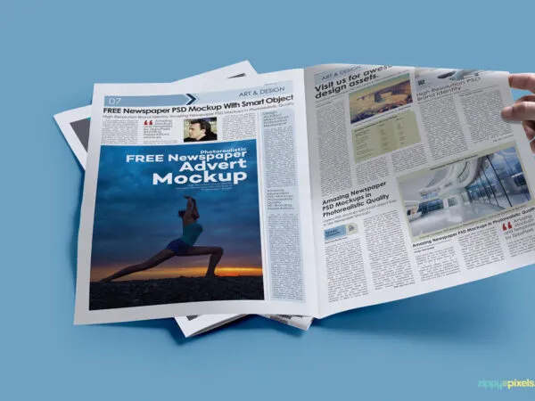 Hand Holding Opened Newspaper Laid on the Ground Mockup 1