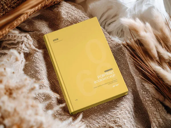 Hardcover Book Cover Mockup on Cozy Fabric Scene 1