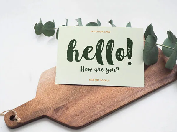 Invitation Card Laid on a Wooden Board Mockup 1
