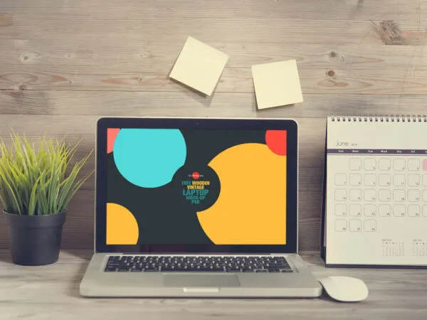 Laptop Opened on a Wooden Desk in Front View Mockup 1