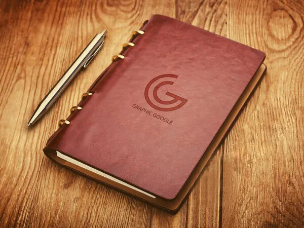 Leather Notebook Cover with Emboss Logo Mockup on Wooden Surface 1