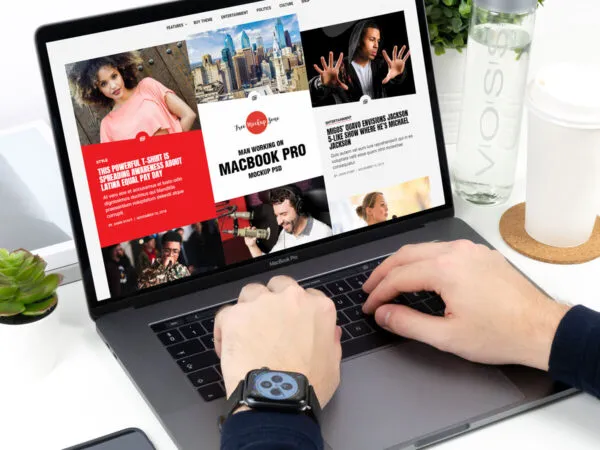 MacBook Pro Mockup Featuring Mans Hands Working with it in Perspective 1