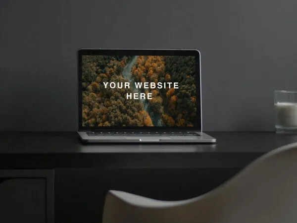 MacBook Screen Mockup on Desk with a Candle on the Right Side 1