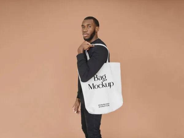 Man Carrying a Large Canvas Bag on His Shoulder Mockup 1