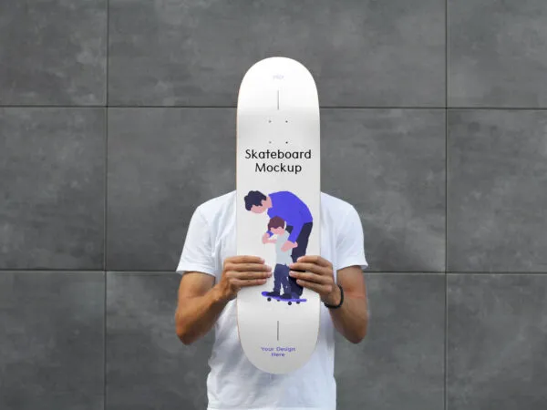 Man Holding Skateboard Mockup Against Brick Wall 1