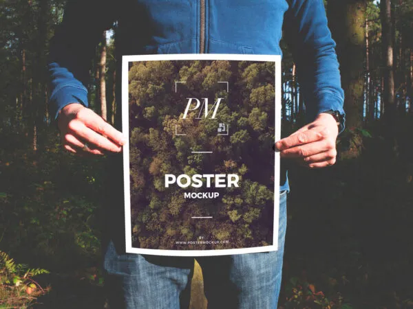 Man Holding a Nature Oriented Poster Mockup 1