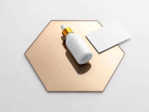 Mockup Displaying Dropper Bottle and Business Card on a Hexagon Mirror 1