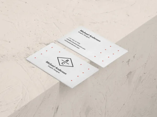 Mockup Displaying Two Business Cards Placed on the Edge of Stone Surface 1