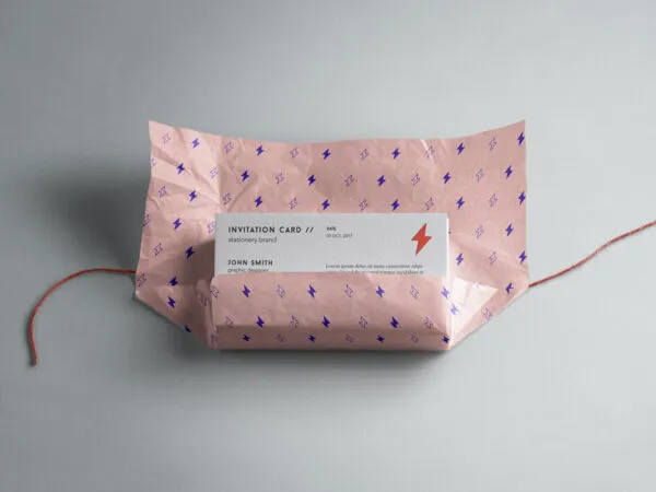 Mockup Displaying a Sack of Invitation Cards Partially Wrapped in a Paper 1
