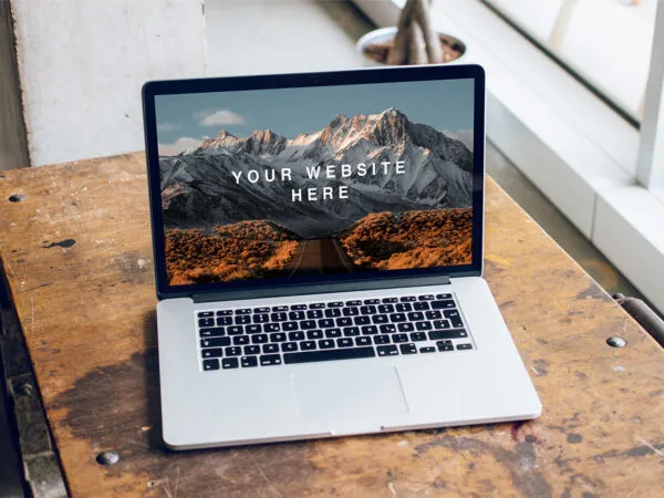 Mockup Featuring Open MacBook Pro on a Wooden Desk 1