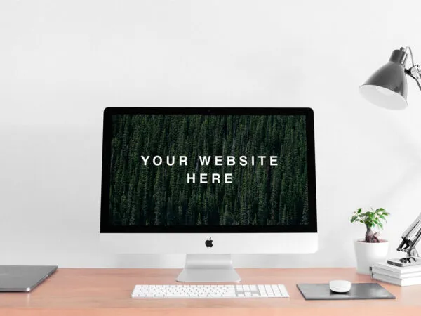 Mockup Featuring Realistic iMac on a Desk Next to a Lamp and a Plant 1
