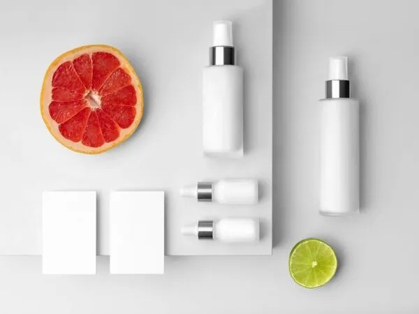 Mockup Featuring Spray and Dropper Bottles Business Cards Beside Tropical Fruits 1