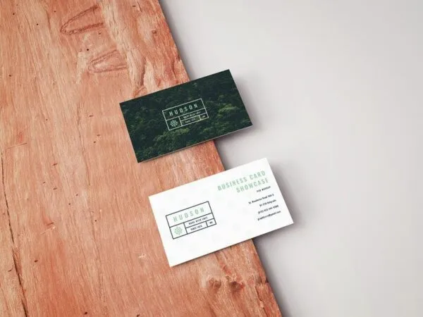 Mockup Featuring Two Business Cards Laid on Wooden Board in Perspective 1