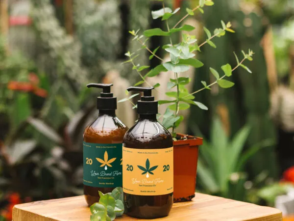 Mockup Featuring Two Glass Pump Dispenser Bottles Standing in a Greenhouse 1