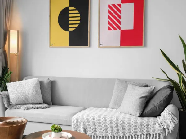 Mockup Featuring Two Posters Hanging Above Couch in Living Room 1