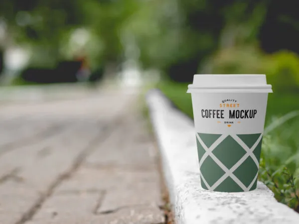 Mockup Featuring a Coffee Cup Placed on the Sidewalk 1